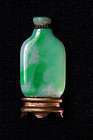 IMPORTANT MID QING DYNASTY LOTUS POND JADEITE SNUFF BOTTLE