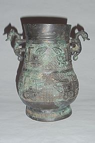 A Rare Zhou Dynasty Bronze Zun with Archaic Motifs/Dragon-Handles