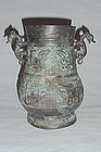 A Rare Zhou Dynasty Bronze Zun with Archaic Motifs/Dragon-Handles