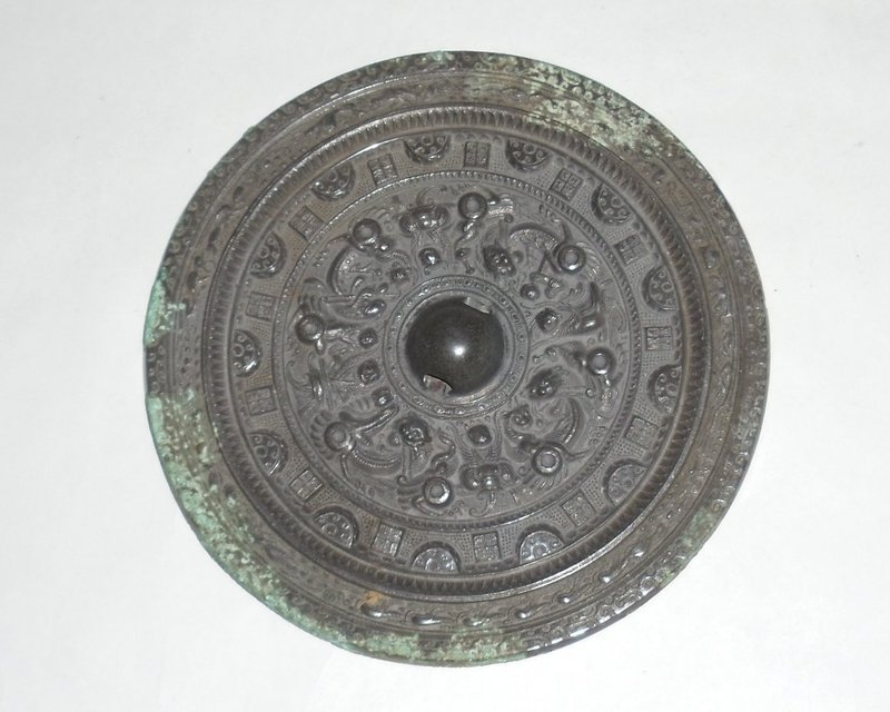 A Rare Bronze Mirror with Archaic Motifs