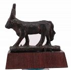 Ancient egyptian bronze apis bull statuette on a wooden base