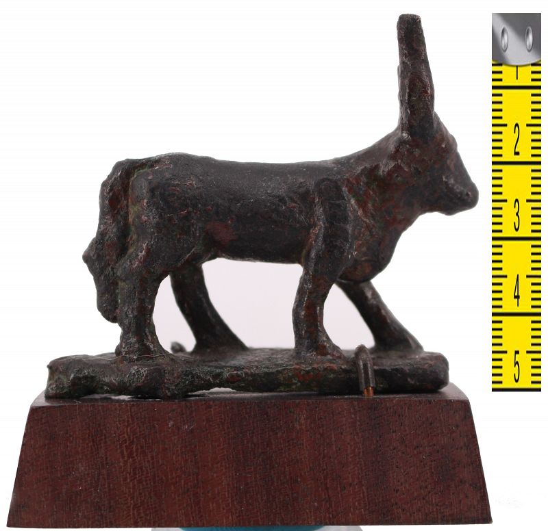 Ancient egyptian bronze apis bull statuette on a wooden base