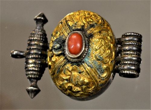Chinese or Tibetan reliquery pendant in silver gilt and coral.