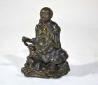 Budai seated on a rock.Bronze. China Qing dynasty or before.