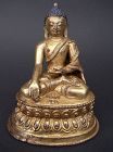 Tibetan Fire Gilt Bronze Image of Akshobya Buddha, 15th c.