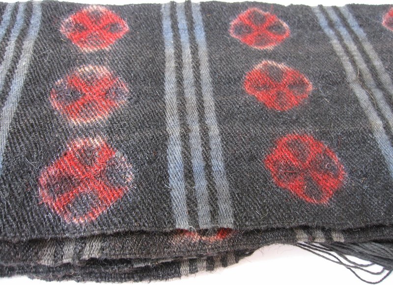 A vintage Tibetan wool sash depicting tigma motifs