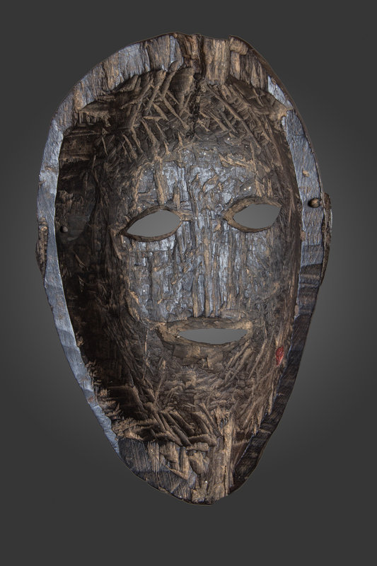 Old black patina mask from East Nepal, Himalaya