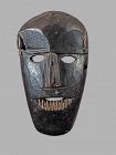 Black primitive mask from West Nepal,