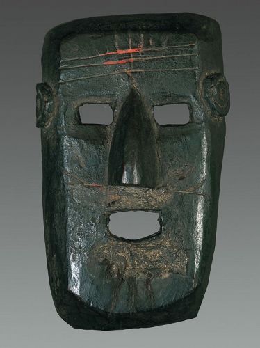 Old black patina mask from West Nepal, Himalya