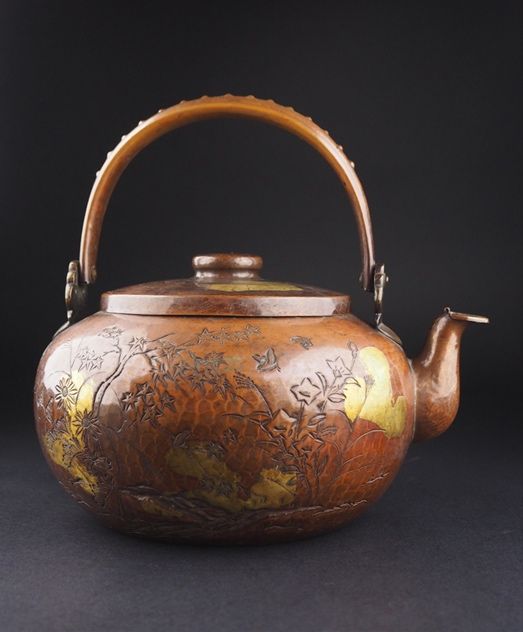 An Antique Copper Teapot with Gold Highlights