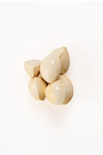 A Japanese ivory netsuke depicting six ginkgo nuts