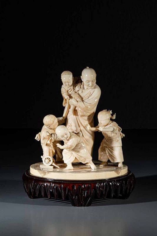 A Japanese ivory okimono depicting a scene of family life