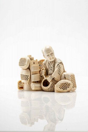 A Japanese ivory okimono depicting a craftsman