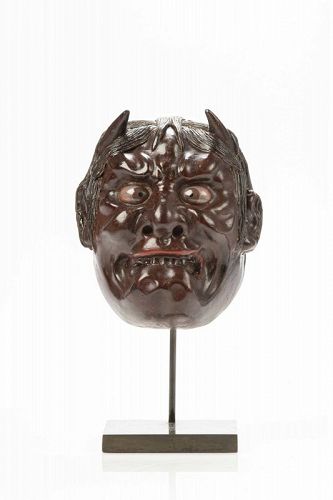 A Japanese lacquered wood oni mask