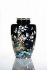 A cloisonné vase depicting a pheasant surrounded by blooming cherry