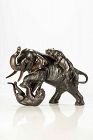 A Japanese bronze okimono depicting an elephant with two tigers