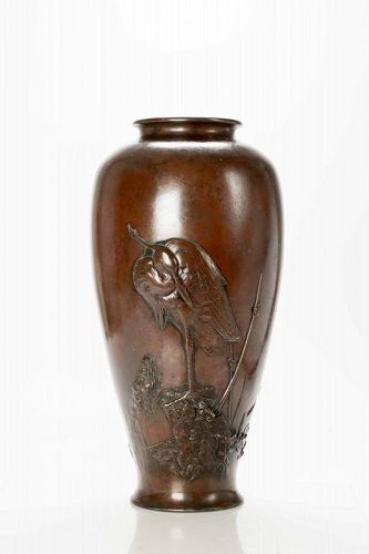 A large bronze vase depicting an egret