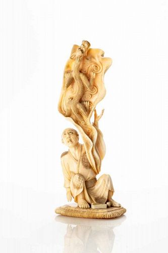 A marine ivory okimono depicting a Ryu dragon with a character