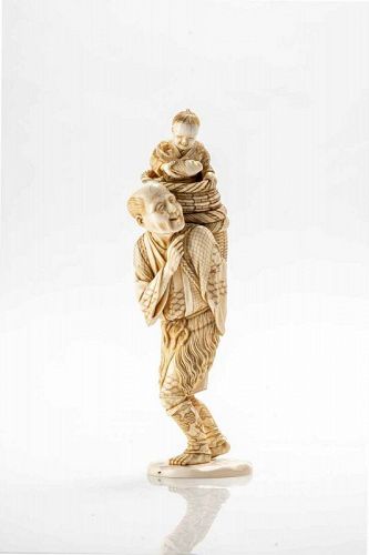 An ivory okimono depicting a fisherman with his child