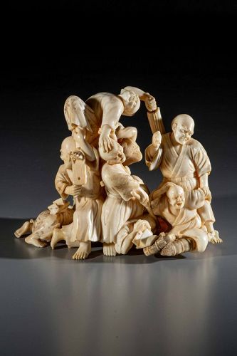 An ivory okimono with blind travelers defending themselves