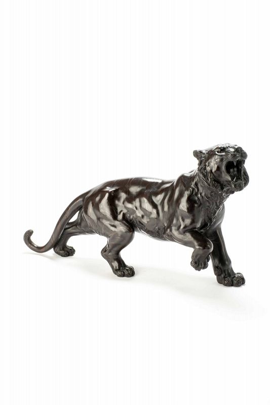 A bronze sculpture depicting the study of a powerful tiger