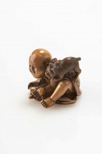 A Japanese ivory netsuke depicting a child with a turtle and a cat