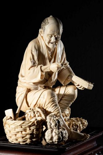 An ivory okimono depicting a farmer on a bamboo stick