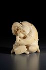An ivory okimono from the Tokyo school depicting a monkey