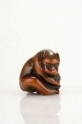 A Japanese netsuke depicting a monkey with a turtle