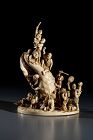 An ivory okimono depicting figures around a shell, signed Kosuke