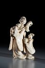 An ivory okimono depicting a family scene, signed Norikazu