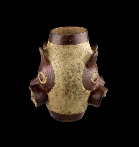 A splendid barrel shaped Moche vessel with Feline heads w large fangs