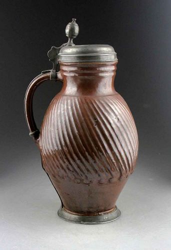 High quality 18th. century pewter mounted brown saltglaze pottery jug