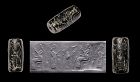 Blackstone cylinder seal w Ashur or Great King drinking, Neo-Assyrian