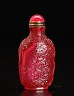 FINE RUBY RED PEKING GLASS SNUFF BOTTLE WITH CARVINGS
