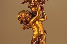 A FRENCH GILDED  CHERUB/CUPID CANDLE HOLDER