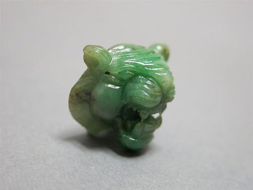 RARE AND FINELY CARVED JADEITE-JADE APPLE GREEN TIGER, 18/19TH CENTURY