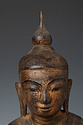 FINE GENUINE SHAN STATE SOLID WOODEN BUDDHA SUBDUING MARA, 18TH CENT.