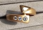 An 18K. GOLD RING SET WITH 3 BRILLIANT DIAMONDS