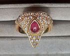 Finest 18K.Gold Ring set with Diamonds and a Cabochon Ruby.
