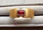 An 18k. BRUSHED GOLD RING SET WITH A GENUINE OCTAGON RUBY