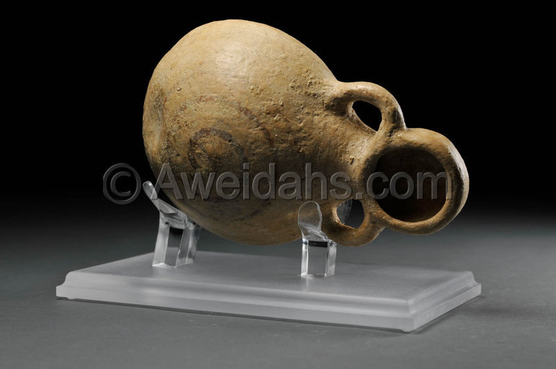 Biblical Iron Age wine flask with an attached cup, 1000 BC