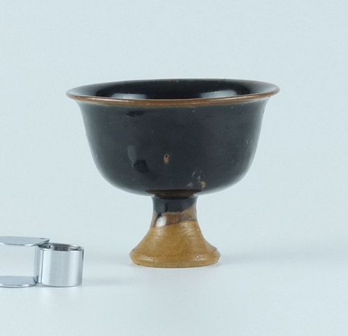 A Chinese, black glazed stem cup; Yuan dynasty