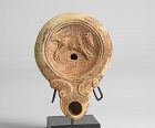 Roman oil lamp with running bull and maker's mark