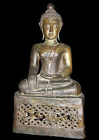 A Thai or Laos gilt-bronze figure of a seated Buddha.