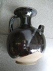 A Chinese phosphatic and treacle brown glaze stoneware