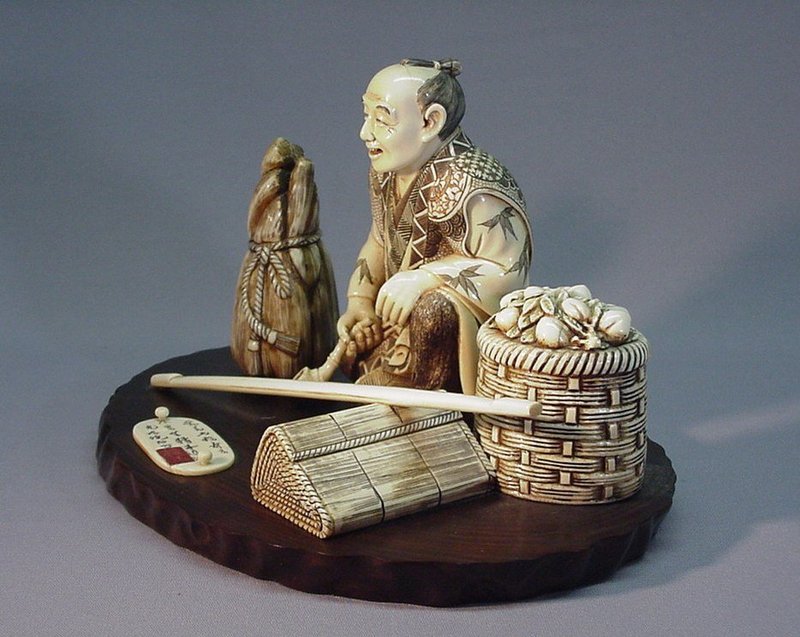 JAPANESE IVORY OKIMONO OF A MERCHANT