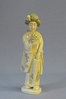 JAPANESE LATE MEIJI PERIOD IVORY OKIMONO OF A GEISHA
