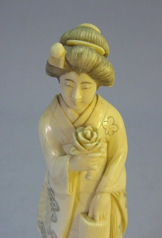 JAPANESE LATE MEIJI PERIOD IVORY OKIMONO OF A GEISHA