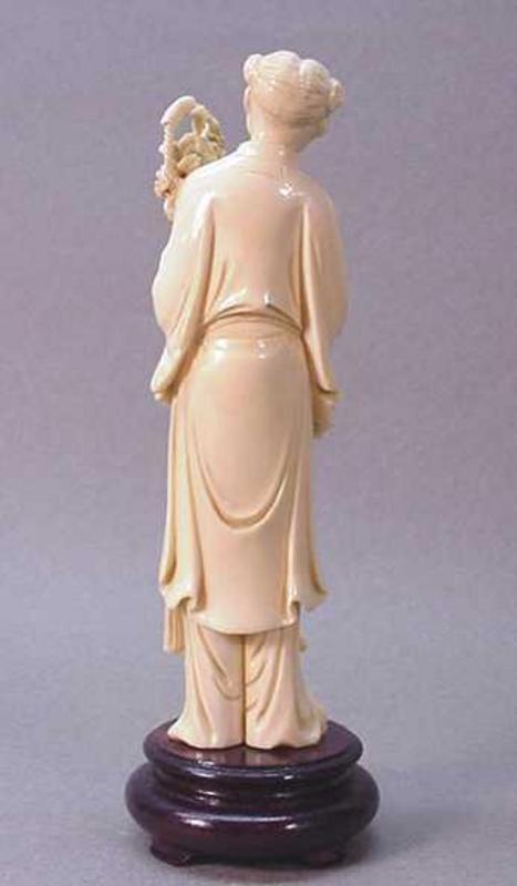 CHINESE CARVED IVORY GIRL HOLDING A BASKET